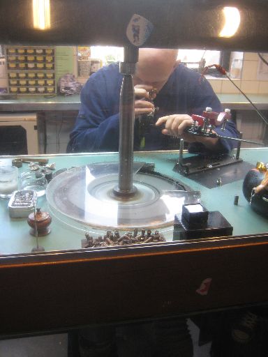 A worker inspecting a polished diamond cut at Gassan