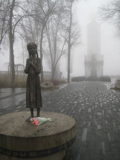 Holodomor memorial (statue in foreground, monument in background